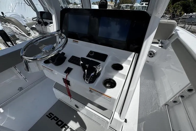Slide: The Image of 2026 Sportsman Heritage 261 Center Console boat dashboard with steering wheel and controls. - 14