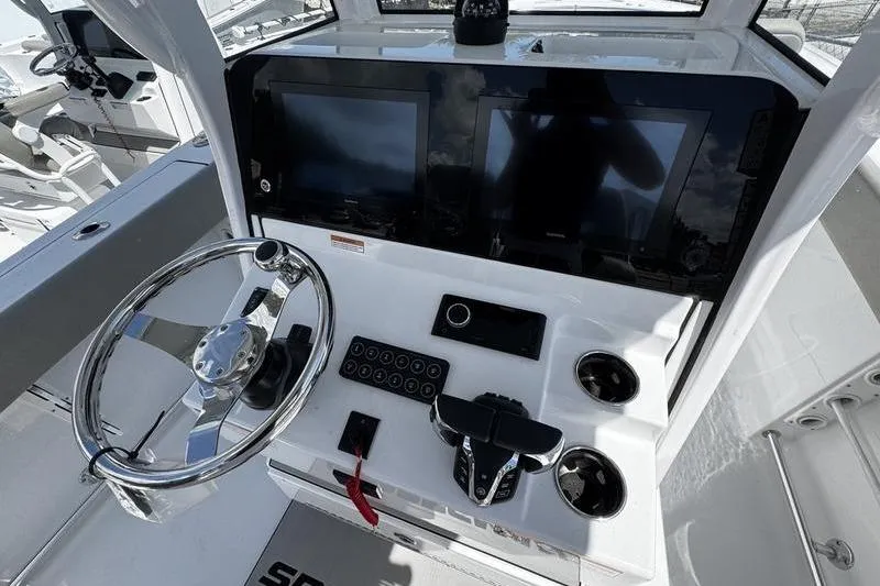 Slide: The Image of 2026 Sportsman Heritage 261 Center Console helm with dual displays and modern controls. - 15