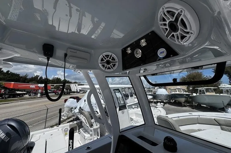 Slide: The Image of Interior view of 2026 Sportsman Heritage 261 Center Console boat, showcasing speakers and control panel. - 16