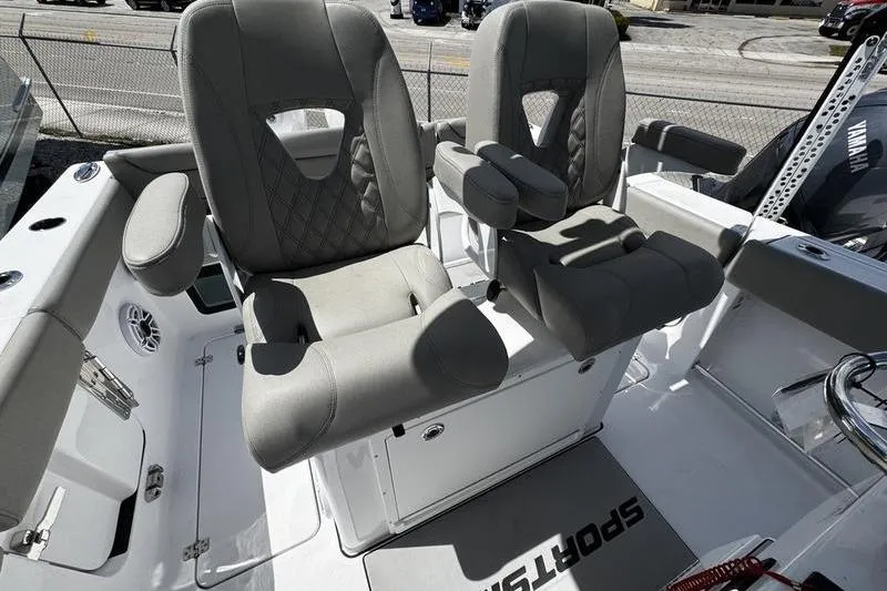 Slide: The Image of 2026 Sportsman Heritage 261 Center Console boat with dual cushioned seats and armrests. - 19
