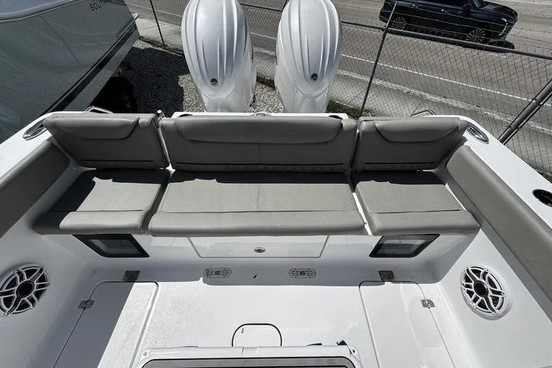 Slide: The Image of 2026 Sportsman Heritage 261 Center Console boat with cushioned seating and dual engines. - 25