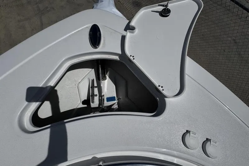 Slide: The Image of Open anchor compartment on 2026 Sportsman Heritage 261 Center Console boat. - 3