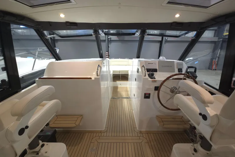 Slide: The Image of Interior of 2026 MJM 3 boat with modern helm and seating. - 1