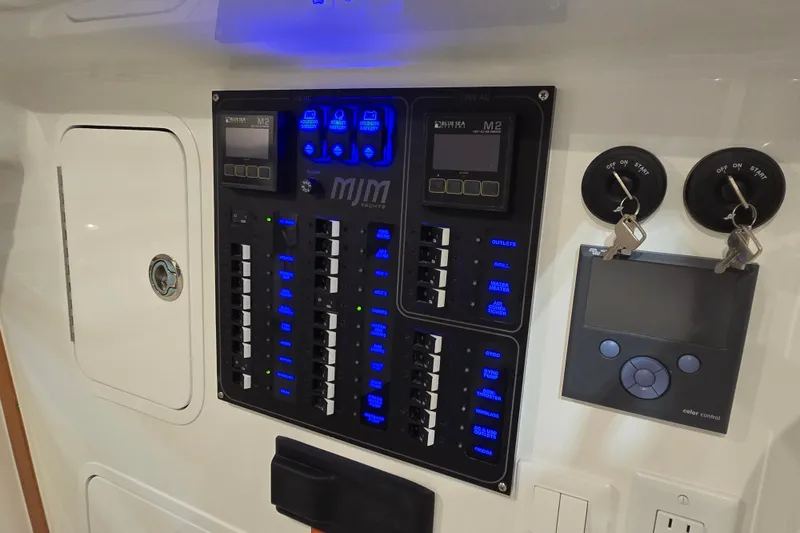 Slide: The Image of Electrical control panel on a 2026 MJM 3 yacht with illuminated switches and keys. - 24