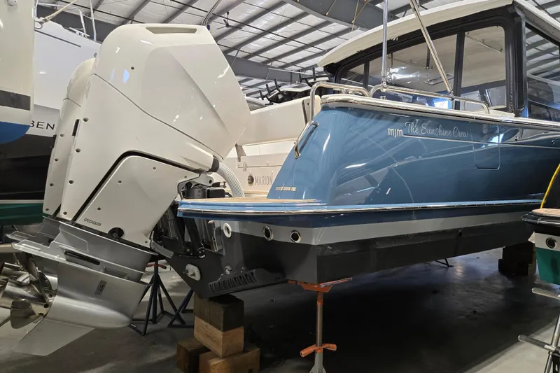 Slide: The Image of 2026 MJM 3 boat in a warehouse, featuring a powerful outboard motor. - 27