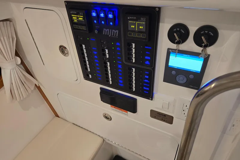 Slide: The Image of Control panel of 2026 MJM 3 boat with switches and digital displays. - 30
