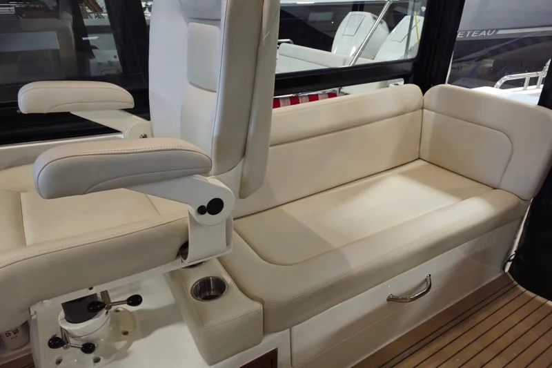 Slide: The Image of Luxurious seating on 2026 MJM 3 boat, featuring cream leather upholstery and armrests. - 6