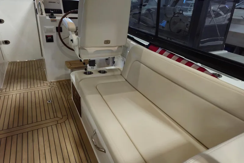 Slide: The Image of Interior of 2026 MJM 3 boat with beige seating and wooden flooring. - 7