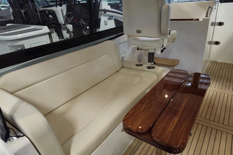 Slide: The Image of Interior of 2026 MJM 3 boat with beige seating and wooden table. - 8