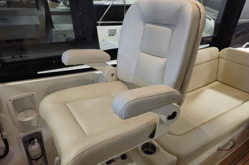 Slide: The Image of Luxurious seating on 2026 MJM 3 boat, featuring plush cream upholstery and armrests. - 9