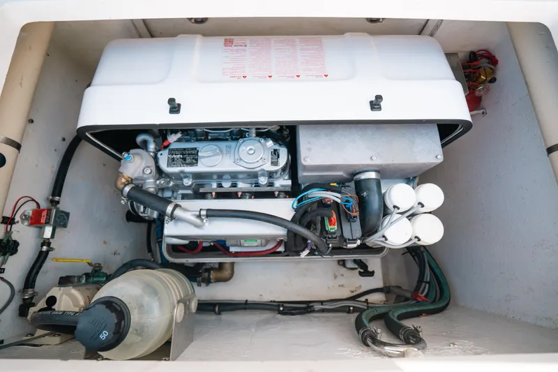 Slide: The Image of Engine compartment of a 2009 Intrepid 475 Sport Yacht, showcasing mechanical components. - 10