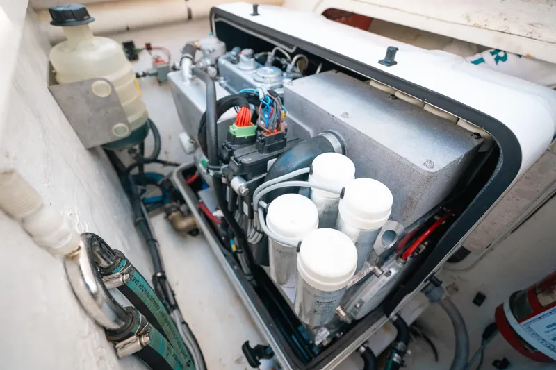Slide: The Image of Engine compartment of a 2009 Intrepid 475 Sport Yacht, showcasing mechanical components. - 11