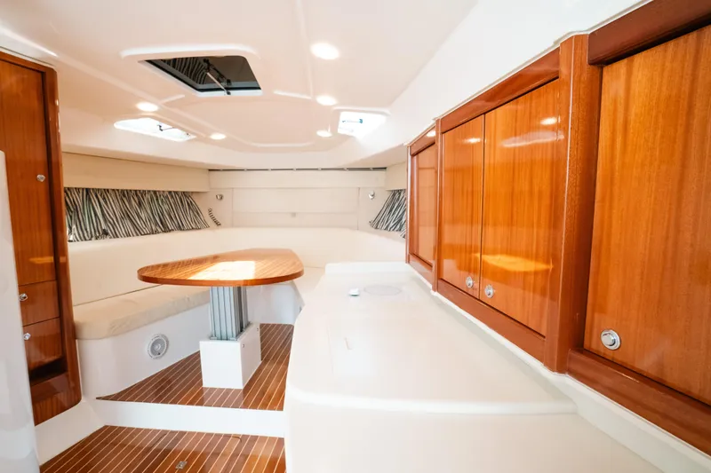 Slide: The Image of Luxurious interior of 2009 Intrepid 475 Sport Yacht with wood cabinetry and seating area. - 16