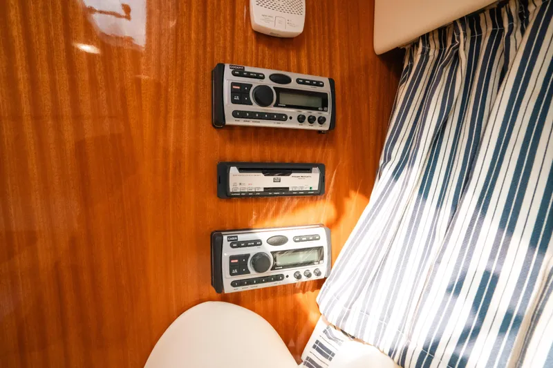 Slide: The Image of Control panel inside 2009 Intrepid 475 Sport Yacht with striped curtain background. - 19