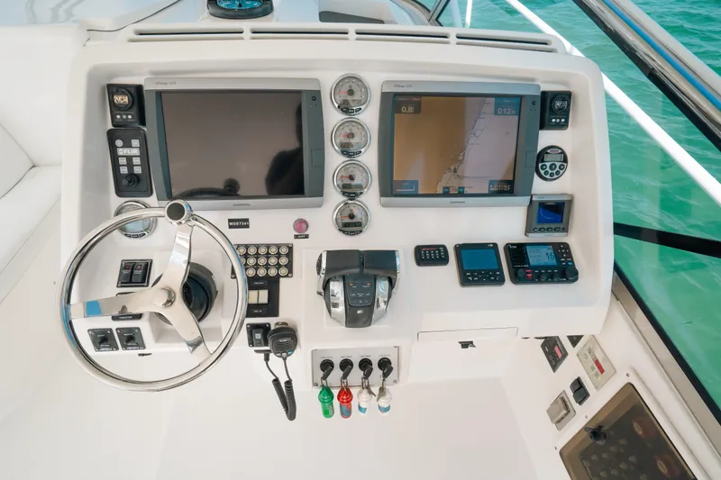 Slide: The Image of 2009 Intrepid 475 Sport Yacht helm with navigation screens and controls. - 32
