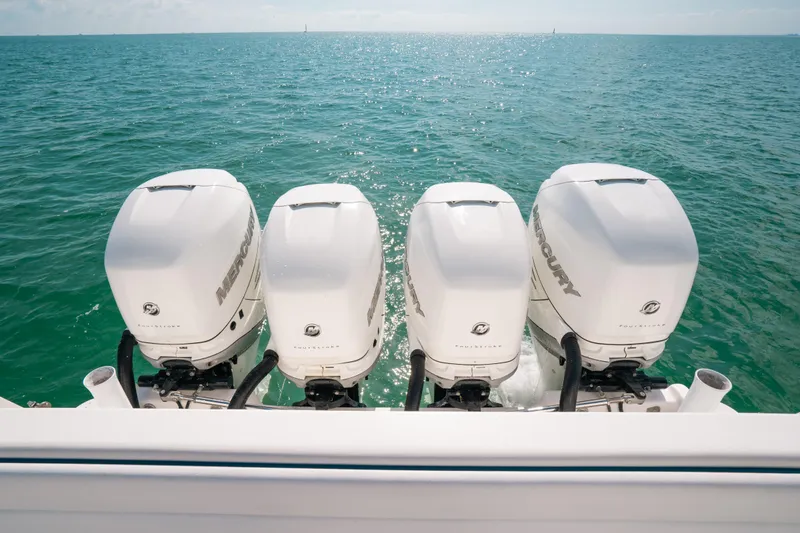 Slide: The Image of Four Mercury outboard engines on a 2009 Intrepid 475 Sport Yacht in open water. - 37