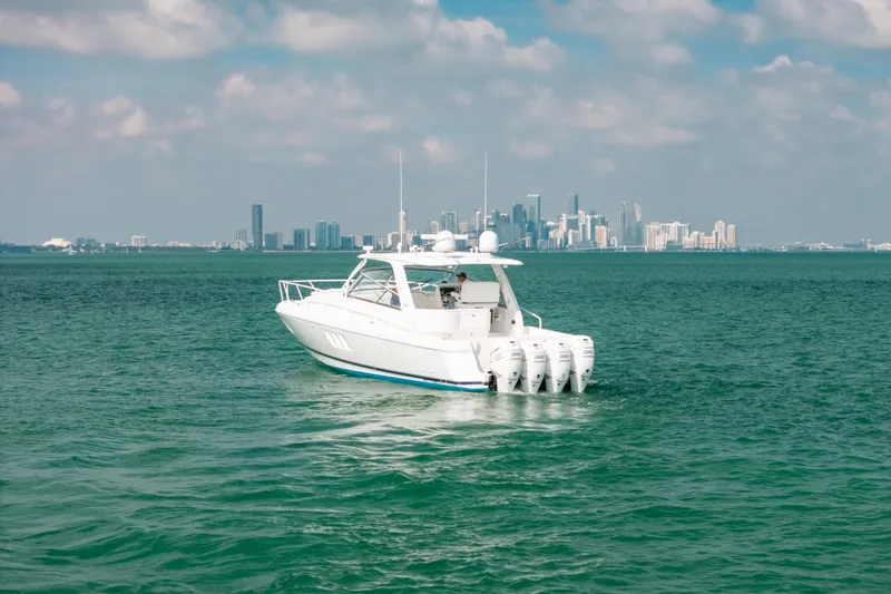 Slide: The Image of 2009 Intrepid 475 Sport Yacht cruising with city skyline in background. - 45