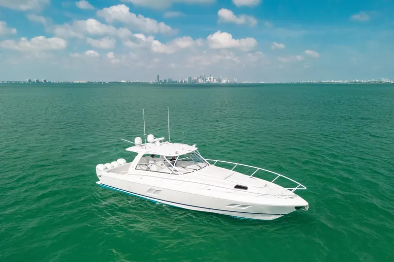 Slide: The Image of 2009 Intrepid 475 Sport Yacht cruising on turquoise waters under a clear sky. - 52