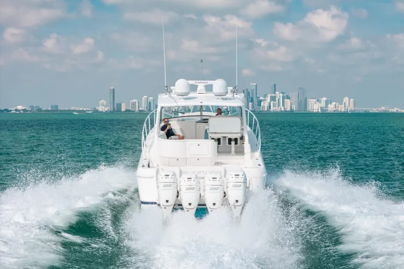 Slide: The Image of Intrepid 475 Sport Yacht 2009 cruising with city skyline in background. - 54