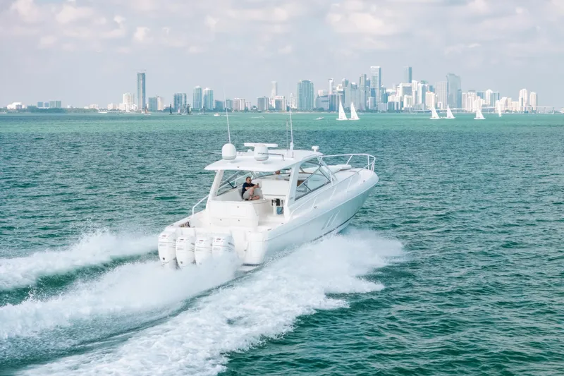 Slide: The Image of 2009 Intrepid 475 Sport Yacht cruising with city skyline in the background. - 55