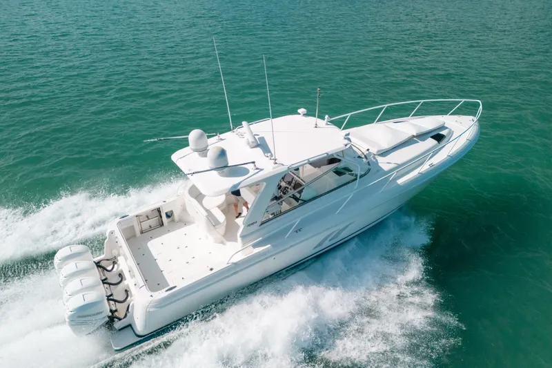 Slide: The Image of 2009 Intrepid 475 Sport Yacht cruising on clear blue waters. - 58