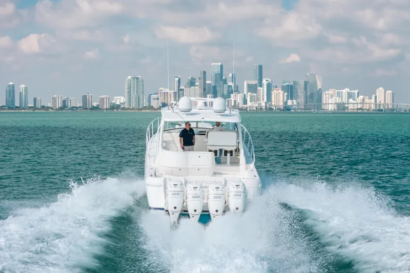 Slide: The Image of 2009 Intrepid 475 Sport Yacht cruising with city skyline backdrop. - 59