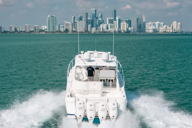 Slide: The Image of 2009 Intrepid 475 Sport Yacht cruising with city skyline in background. - 60