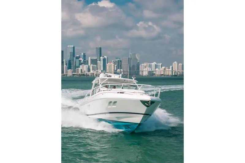 Slide: The Image of 2009 Intrepid 475 Sport Yacht cruising near city skyline on a sunny day. - 62