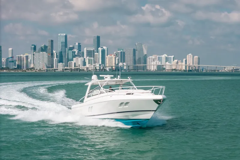 Slide: The Image of 2009 Intrepid 475 Sport Yacht cruising near a city skyline on a sunny day. - 63