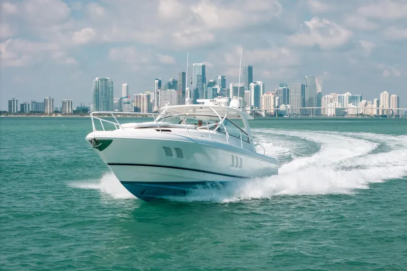 Slide: The Image of Intrepid 475 Sport Yacht cruising near city skyline, 2009 model. - 64