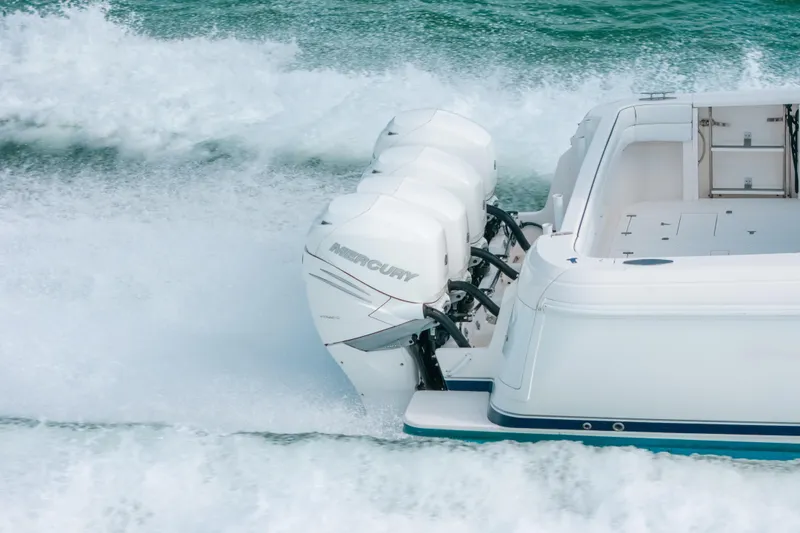 Slide: The Image of 2009 Intrepid 475 Sport Yacht with powerful Mercury outboard engines cruising on water. - 68