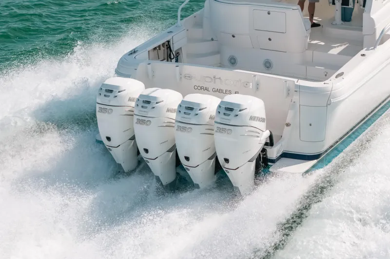 Slide: The Image of 2009 Intrepid 475 Sport Yacht with four powerful outboard engines cruising on the water. - 69