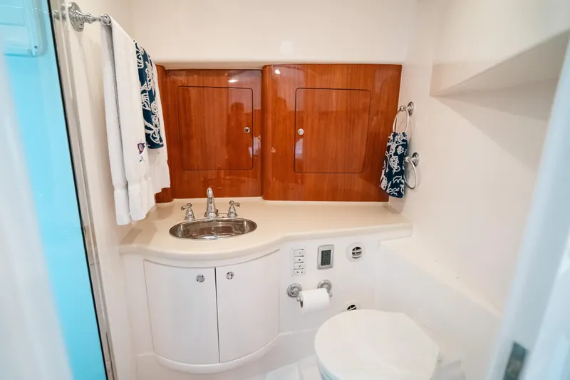 Slide: The Image of Luxurious bathroom in 2009 Intrepid 475 Sport Yacht with wood accents and modern fixtures. - 7