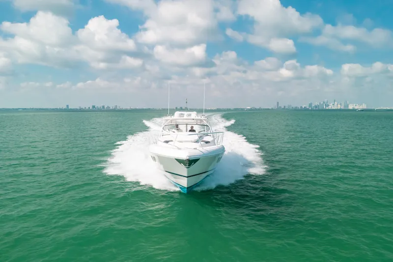 Slide: The Image of 2009 Intrepid 475 Sport Yacht cruising on open water under a partly cloudy sky. - 71