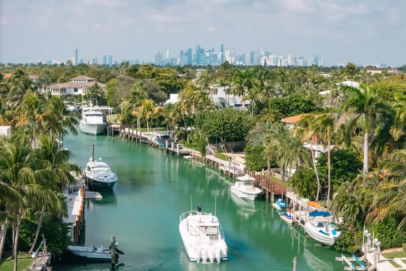 Slide: The Image of Canal view with 2009 Intrepid 475 Sport Yacht, palm trees, and city skyline in the background. - 73