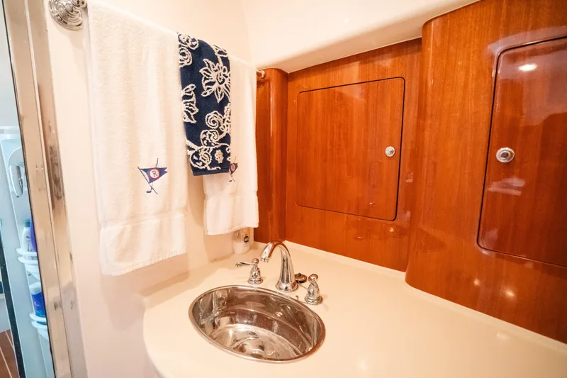 Slide: The Image of Luxurious bathroom interior of 2009 Intrepid 475 Sport Yacht with wooden cabinets and sink. - 8