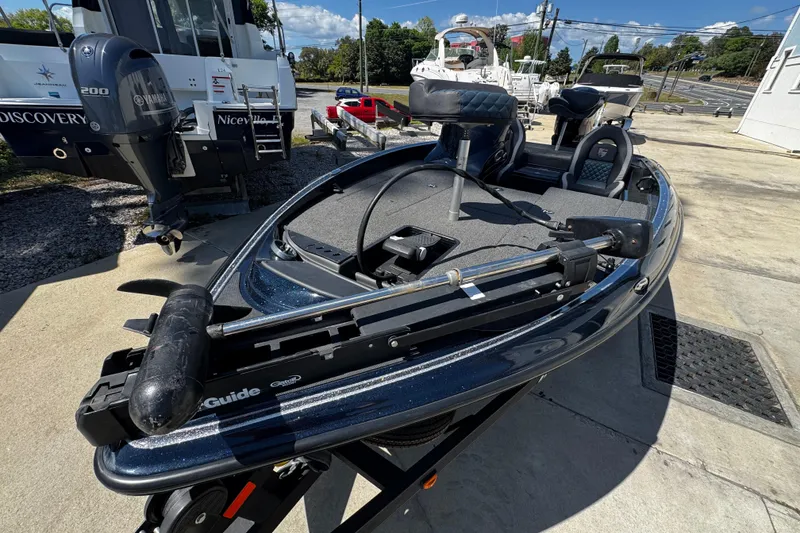Slide: The Image of 2022 Triton 179 TrX boat with Yamaha motor, parked outdoors on a sunny day. - 5