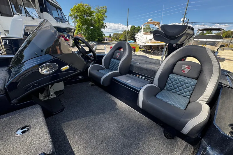 Slide: The Image of 2022 Triton 179 TrX boat interior with dual cushioned seats and steering console. - 6