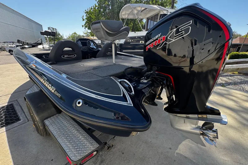 Slide: The Image of 2022 Triton 179 TrX boat with Mercury Pro XS engine, parked outdoors. - 7