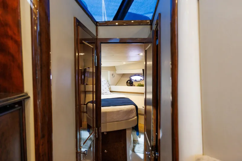 Slide: The Image of Luxurious interior of a 2010 Meridian 391 Sedan yacht, featuring a cozy bedroom. - 19