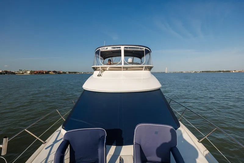 Slide: The Image of 2010 Meridian 391 Sedan yacht cruising on a calm lake under clear blue skies. - 23