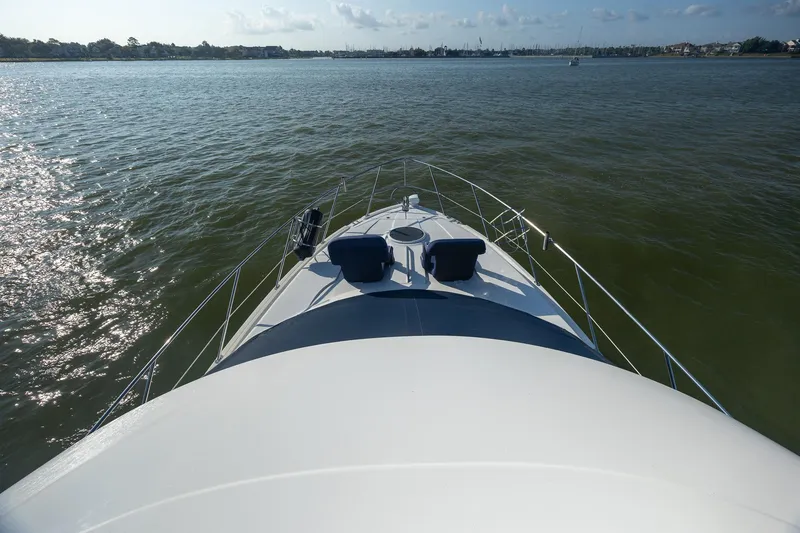 Slide: The Image of 2010 Meridian 391 Sedan yacht cruising on calm waters under a clear sky. - 24