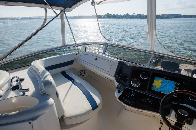 Slide: The Image of 2010 Meridian 391 Sedan helm with navigation system, overlooking serene waters. - 25
