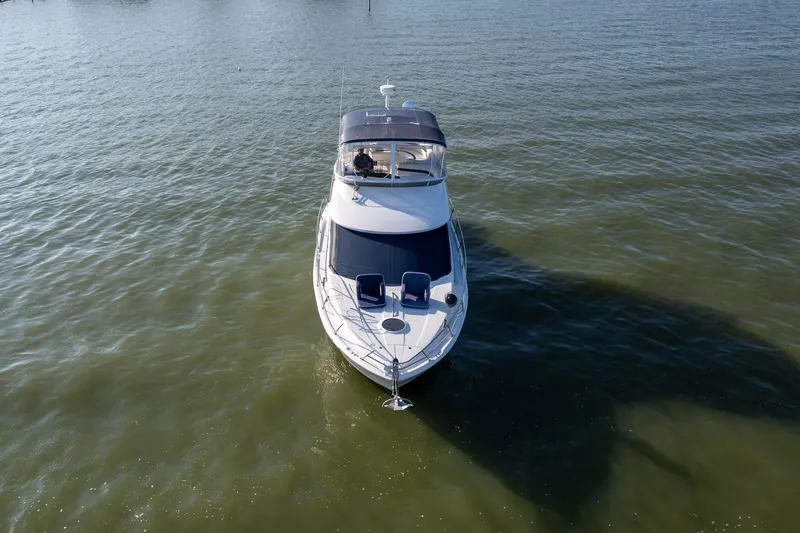 Slide: The Image of 2010 Meridian 391 Sedan yacht cruising on calm waters, aerial view. - 3