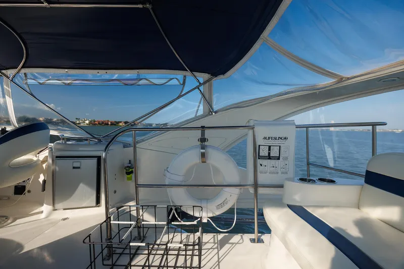 Slide: The Image of 2010 Meridian 391 Sedan yacht interior with seating, life preserver, and ocean view. - 30