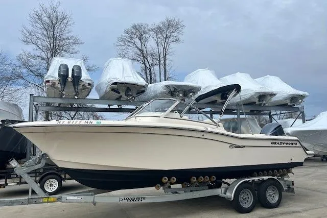 The Image of 2018 Grady-White Freedom 235 boat on trailer, surrounded by covered boats. - 0