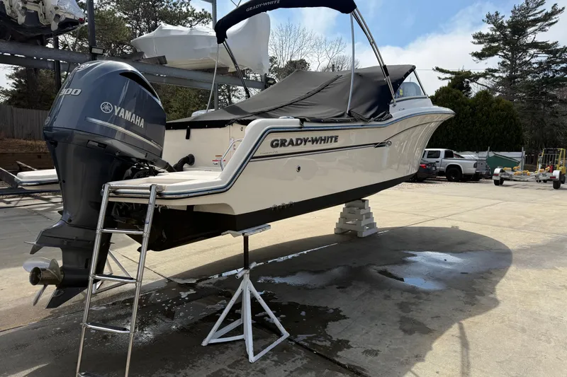 Slide: The Image of 2018 Grady-White Freedom 235 boat with Yamaha engine on a stand outdoors. - 10