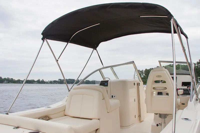 Slide: The Image of Manufacturer Provided Image: 2018 Grady-White Freedom 235 boat interior with canopy on a lake. - 14