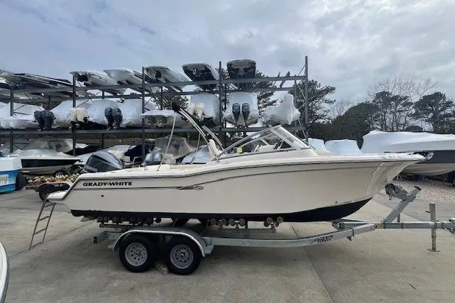 Slide: The Image of 2018 Grady-White Freedom 235 boat on trailer, parked in marina storage area. - 2
