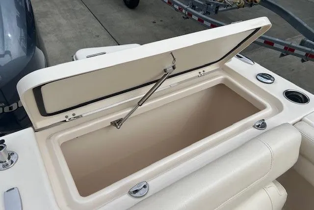 Slide: The Image of Open storage compartment on 2018 Grady-White Freedom 235 boat, showcasing interior space. - 22